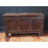 A late 17th/early 18th century oak coffer of panelled construction, the hinged lid with a moulded