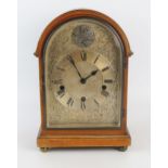 A mahogany mantel clock of arched outline with silvered arched Roman dial, the HALLER triple train