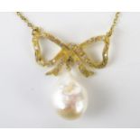 An 18ct Gold and Baroque untested pearl pendant on a diamond set ribbon suspension and integral