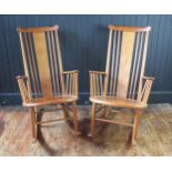 A pair of teak rocking chairs with solid central splat and spindle back with solid seat on rocker