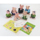 A set of Nat West pottery piggy banks, includes complete family and two cousin Wesley, together with