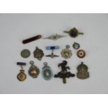 A collection of assorted silver and other sporting badges, Arm cap badge, RAF sweetheart brooch etc.