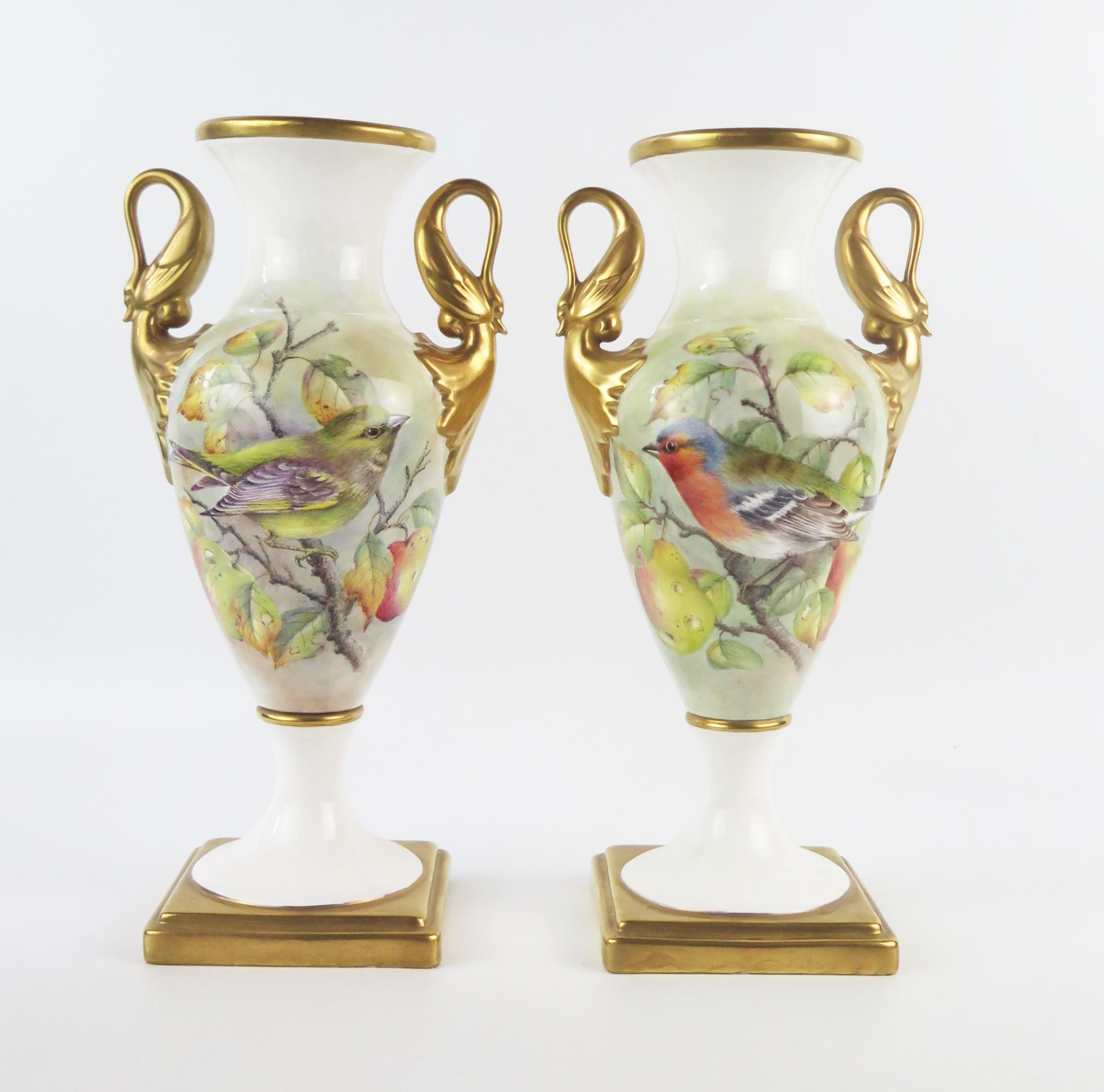A pair of G Delaney porcelain twin handled vases, of ovoid form, the gilded handles modelled as - Image 2 of 3