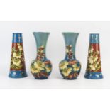 A pair of Exeter Art Pottery vases of conical tapering form with low relief floral decoration,