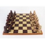 A studio pottery chess set, one side in light tan glaze the other side in dark brown treacle