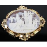 A Large Shell Cameo Brooch in a 9ct gold mount decorated with two ladies and putti in a garden