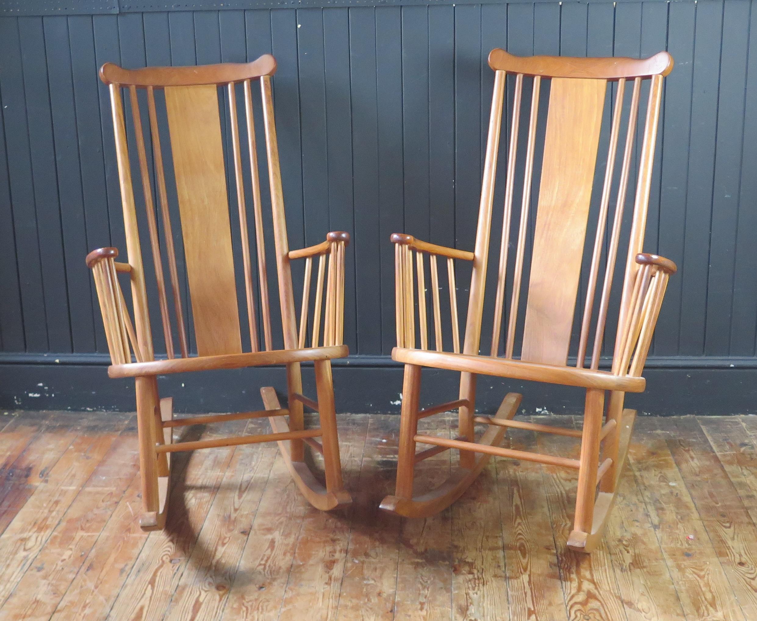 A pair of teak rocking chairs with solid central splat and spindle back with solid seat on rocker - Image 2 of 3