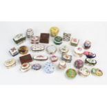 A collection of porcelain and gilt metal mounted pill boxes, patch box, glass paperweight,