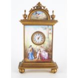 A Viennese gilt metal and enamel bedside timepiece, of arched outline, the pediment decorated with a