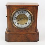 A walnut and brass strung mantel clock, of rectangular outline, with canted corners, with 12cm