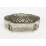 An Indo-Persian silver box of cartouche-shaped outline, with embossed floral decoration, 9.5cm wide,