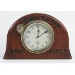 A World War Two period mantel timepiece of arched outline with incised script "4th Devons, CIB,