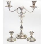 A silver plated twin branch candelabra with reeded swept arms, on a knopped stem and weighted