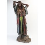 A painted plaster figure of a semi-naked Arab woman with long flowing hair, robes and dress, 74cm