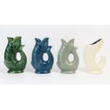 Three Dartmouth Pottery cod gurgle jugs in blue, grey and green glazes each 19cm high, together with