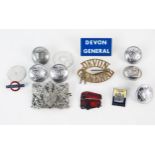 A Devon General brass cap badge, buttons, enamel bus badge and other items.