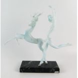 A glass figure group of nude dancing female and stag, mounted on a marble base, 29cm high.