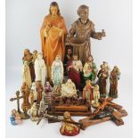 A collection of plaster, porcelain and wooden religious figures including Christ, St Anthony, St.