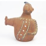 A Pozancos pottery figural book end, modelled as a rotund man with outstretched arm, 26cm high.