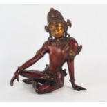 An Eastern bronze figure of a seated deity, 24cm high.