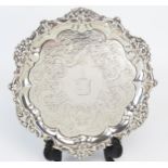 A George IV Silver waiter, maker EB, London, 1828, crested, enclosed by chased decoration, with