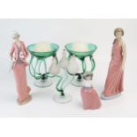 Three Nao porcelain figurines, a pair of clear and green glass candle holders and a clear and