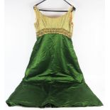 A Henri Bendel green satin cocktail dress, with applied beads and paste stones to the pale lemon