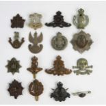 A collection of British regimental cap badges, includes Royal Scots Guards, Royal Artillery,