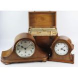 An oak mantel clock of arched outline, 50cm wide, a smaller arched mantel clock, 26cm wide