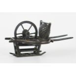 A Chinese silver model of a cart, maker Wang Hing, with single spoked wheel, 6.5cm long, 23gms, 0.