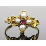 An Antique Ruby and untested Pearl Ring in an unmarked high carat setting with pierced scrolling