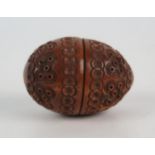 A 19th century carved coquilla nut box, modelled as a two piece egg joined by a turned thread, the