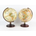 Two World Classic 9ins Terrestrial globes, on polished wood stands, 33cm high.