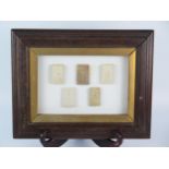 A set of five Thai Buddha votive tablets, mounted and framed.