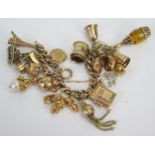 A 9ct Gold Charm Bracelet set with sixteen charms including the Eiffel Tower, the Three Wise
