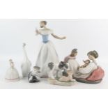 A collection of LLadro porcelain figurines and animals, including a mother and children, a ballet