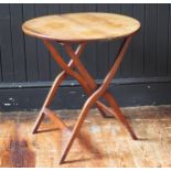 An early 19th century mahogany and brass folding coaching table, the circular hinged top raised on