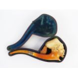 A 19th century carved Meerschaum pipe, in the form of a Zouave, with amber mouthpiece, contained