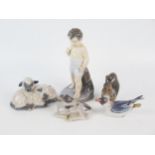 A Royal Copenhagen porcelain figure of a young boy 16cm high together with four Royal Copenhagen