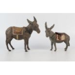 A cold painted spelter money box in the form of a donkey, the saddle marked Clovelly, 10cm long,