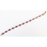 A 7.5" 18ct Gold and Pink Sapphire? Bracelet, c. 7.1x5.5mm stones8.3g