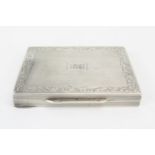 A continental silver card case, stamped marks, initialled, with engine turned decoration, enclosed