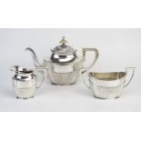 An Austro-Hungarian three-piece tea service, stamped marks, of oval outline, with half reeded