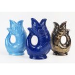 Three Dartmouth Pottery cod gurgle jugs in light blue, dark blue and dark lustre glazes each 18cm
