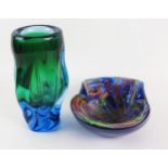 A Madina, blue and green glass of writhen form, 17cm high, together with a variegate glass
