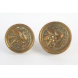 A pair of cast brass door knobs, of circular outline with low relief bird decoration, 6.5cm
