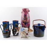 A Torquay ware three handled vase, hand decorated with parrots, 36cm. high, a biscuit barrel with