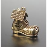 A Hallmarked 9ct Gold Charm 'Old Woman Who Lived in a Shoe, opening to reveal the old woman and