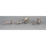 A Silver miniature model of a Sulky, a model of a silver dog cart with driver, together with a