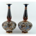 A pair of Royal Doulton Slater pottery vases, of squat circular form with slender necks with